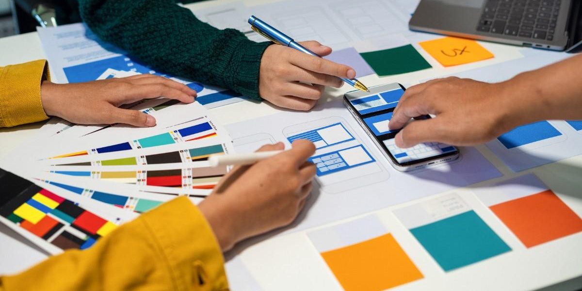 colorful papers on table with hands